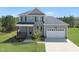 Beautiful two-story home boasting a two-car garage, covered front porch, and a neatly landscaped front yard at 40 Misty Mountain, Spring Hope, NC 27882