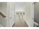 Hallway with hardwood floors leading to a bright and airy living area with windows and outdoor access at 40 Misty Mountain, Spring Hope, NC 27882
