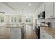 Open kitchen view with large island, granite countertops, stainless appliances, and wood flooring at 40 Misty Mountain, Spring Hope, NC 27882