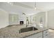Open kitchen view featuring a large island with granite countertops and sink at 40 Misty Mountain, Spring Hope, NC 27882