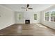 Spacious living room featuring a fireplace, ceiling fan, recessed lighting, and ample natural light from the windows at 40 Misty Mountain, Spring Hope, NC 27882