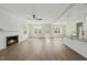 Bright, open living room with a fireplace and windows leading to an island with sink in the kitchen at 40 Misty Mountain, Spring Hope, NC 27882