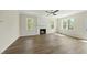 Bright living room with a fireplace, large windows providing natural light, and hardwood floors at 40 Misty Mountain, Spring Hope, NC 27882