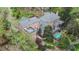 Aerial view of a brick home with a large backyard featuring a pool, deck, and lush landscaping at 5317 Burning Oak Ct, Raleigh, NC 27606