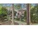 View of the backyard surrounded by mature trees and lush landscaping and a stone walkway at 5317 Burning Oak Ct, Raleigh, NC 27606
