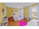 A whimsical bedroom with a canopy bed, hardwood floors, and cheerful decor at 5317 Burning Oak Ct, Raleigh, NC 27606