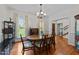 Formal dining room featuring hardwood floors, large windows, and elegant decor at 5317 Burning Oak Ct, Raleigh, NC 27606