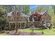 A well-maintained brick home with dormer windows and a covered front porch at 5317 Burning Oak Ct, Raleigh, NC 27606