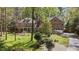 Traditional brick home with a well-manicured front lawn and mature trees at 5317 Burning Oak Ct, Raleigh, NC 27606