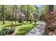 Charming two-story brick home with a lush green lawn and mature trees at 5317 Burning Oak Ct, Raleigh, NC 27606