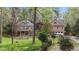 Two stately brick homes with manicured lawns, mature trees, and inviting front entrances for curb appeal at 5317 Burning Oak Ct, Raleigh, NC 27606