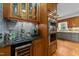 A kitchen featuring a beverage station with a stainless steel oven and tiled backsplash at 5317 Burning Oak Ct, Raleigh, NC 27606