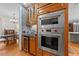 Kitchen area features double ovens, wine fridge and adjacent dining area at 5317 Burning Oak Ct, Raleigh, NC 27606