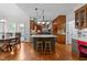 Spacious kitchen features an island with granite countertops, stainless steel appliances, and hardwood floors at 5317 Burning Oak Ct, Raleigh, NC 27606