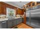 A spacious kitchen featuring ample counter space, a stainless steel refrigerator, and hardwood floors at 5317 Burning Oak Ct, Raleigh, NC 27606
