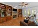 Bright living room featuring a brick fireplace, built-in shelves and french doors that open to a balcony at 5317 Burning Oak Ct, Raleigh, NC 27606