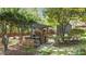 An outdoor kitchen with a stone pizza oven is nestled among mature trees at 5317 Burning Oak Ct, Raleigh, NC 27606