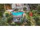 Aerial view of a backyard pool and deck featuring outdoor furniture and beautiful landscaping at 5317 Burning Oak Ct, Raleigh, NC 27606
