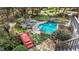 An aerial view of a relaxing backyard pool area, featuring a mini-waterfall and a small bridge at 5317 Burning Oak Ct, Raleigh, NC 27606