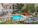 Beautiful backyard pool area with stone accents, surrounded by lush landscaping and a charming red bridge at 5317 Burning Oak Ct, Raleigh, NC 27606