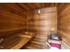 Interior of a cedar sauna with wooden benches, traditional heater, and wood-paneled walls for a relaxing experience at 5317 Burning Oak Ct, Raleigh, NC 27606