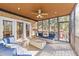Cozy screened-in sunroom with brick walls, comfortable seating, ceiling fan and ample natural light. Perfect for relaxing or entertaining at 5317 Burning Oak Ct, Raleigh, NC 27606
