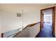 Upstairs hallway with carpeted floors and a view of a bedroom at 76 Traceway N, Sanford, NC 27332