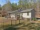 House exterior showcasing a large deck and fenced yard at 7815 Dodsons Crossroads, Hillsborough, NC 27278