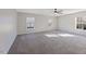 Large bedroom with neutral walls, ceiling fan, and carpet at 900 Blue Thorn Drive Dr, Apex, NC 27539