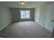 Bedroom with neutral carpet, a window, and double doors to a closet at 114 Arundel Dr, Archer Lodge, NC 27527
