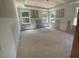 A bright bedroom under construction features multiple windows and a tray ceiling at 114 Arundel Dr, Archer Lodge, NC 27527