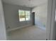 Bright bedroom with a large window offering views of the surrounding landscape at 114 Arundel Dr, Archer Lodge, NC 27527