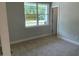 Cozy bedroom with neutral carpet, a bright window, and a view of the outdoors at 114 Arundel Dr, Archer Lodge, NC 27527