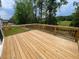 View of the wooden deck overlooking a grassy area and trees, perfect for outdoor enjoyment at 114 Arundel Dr, Archer Lodge, NC 27527