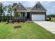 Charming home featuring a stone facade, well-maintained lawn, and a two-car garage at 114 Arundel Dr, Archer Lodge, NC 27527