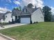 Charming home featuring a two-car garage, tidy lawn, and classic architectural details at 114 Arundel Dr, Archer Lodge, NC 27527