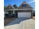 Charming single Gathering home with stone accents, a two car garage, and a concrete driveway at 114 Arundel Dr, Archer Lodge, NC 27527