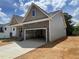 A modern home with stone accents, and a large two-car garage on a sunny day at 114 Arundel Dr, Archer Lodge, NC 27527