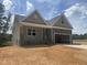 Charming new construction home featuring stone accents, a two-car garage, and a welcoming covered front porch at 114 Arundel Dr, Archer Lodge, NC 27527