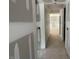 An open hallway with unfinished walls leading to other rooms in the new construction home at 114 Arundel Dr, Archer Lodge, NC 27527
