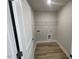 A practical laundry room equipped with shelving, flooring, and hookups at 114 Arundel Dr, Archer Lodge, NC 27527