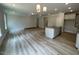 Open-concept living room and kitchen area with wood floors, granite island, and recessed lighting at 114 Arundel Dr, Archer Lodge, NC 27527