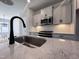 Stone countertop island that features a stainless sink and matte-black faucet at 136 Weavers Grove Dr, Chapel Hill, NC 27514