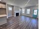 Open-concept living room with hardwood floors, a fireplace, and ample natural light at 136 Weavers Grove Dr, Chapel Hill, NC 27514