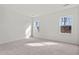 Bright bedroom with carpet flooring, white walls, natural light from two windows, and ample space at 160 Babbling Brook Dr, Clayton, NC 27520