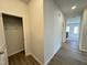 View of hallway with wood-look floors, closet, and entryway to carpeted area at 170 Vega Loop, Sanford, NC 27330