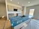 Kitchen with light gray cabinets, blue countertops, and an island at 170 Vega Loop, Sanford, NC 27330