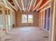 An unfinished bedroom shows the framework, windows, bathroom, and plumbing for a new residence at 203 Pond Vw Ct # 1, Fuquay Varina, NC 27526