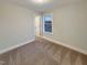 Cozy bedroom with natural light from the window and neutral carpet at 203 Pond Vw Ct # 1, Fuquay Varina, NC 27526