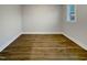 Bright bedroom featuring wood flooring and a window offering natural light at 203 Pond Vw Ct # 1, Fuquay Varina, NC 27526